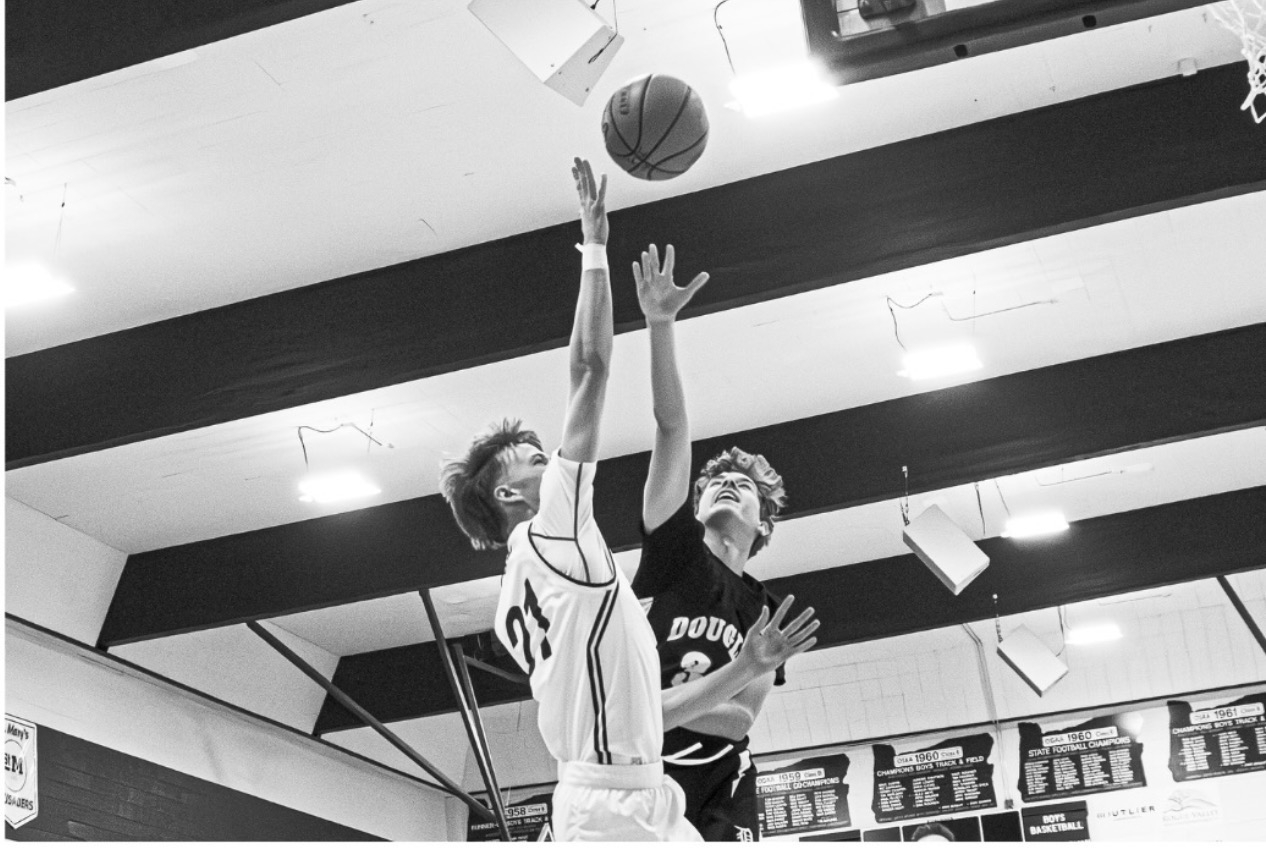 Tai Zimmerman contesting a shot in black and white